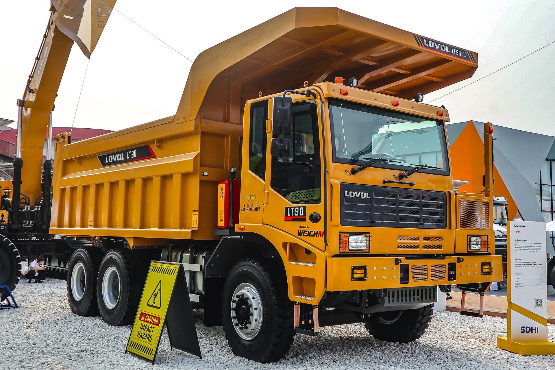 A dump truck carries ore, waste rock and construction material in a tipping body.