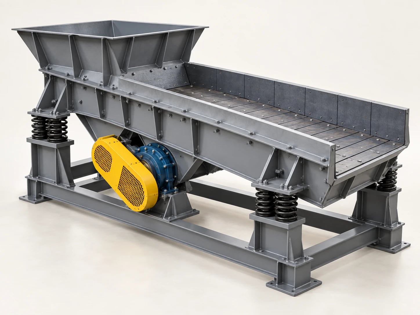 A vibrating feeder delivers material from a hopper to a crusher at a controlled feed rate.