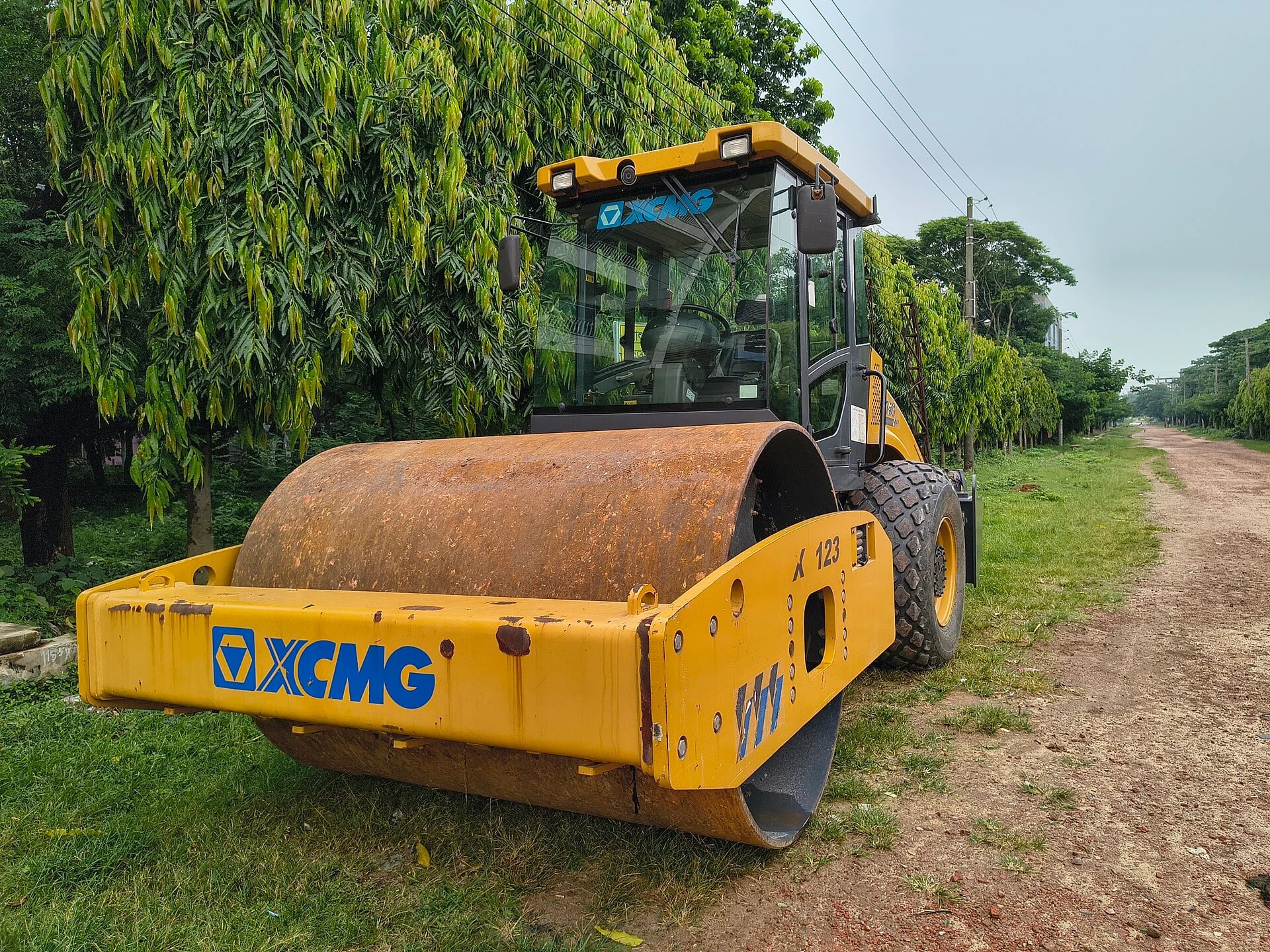 A vibratory roller compacts road and foundation material through drum weight and vibration.